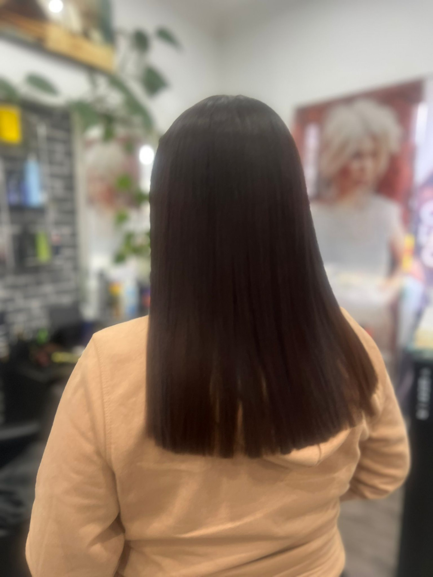 Long dark hair after a keratin smoothing treatment, sleek and shiny