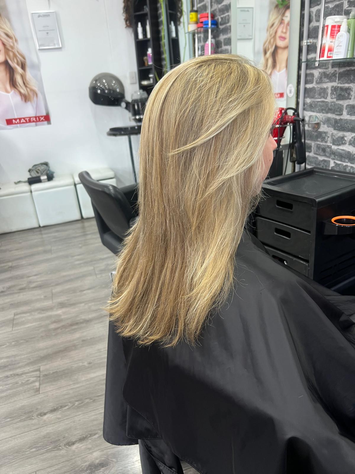 Blonde layered cut with soft foils and a smooth blow dry