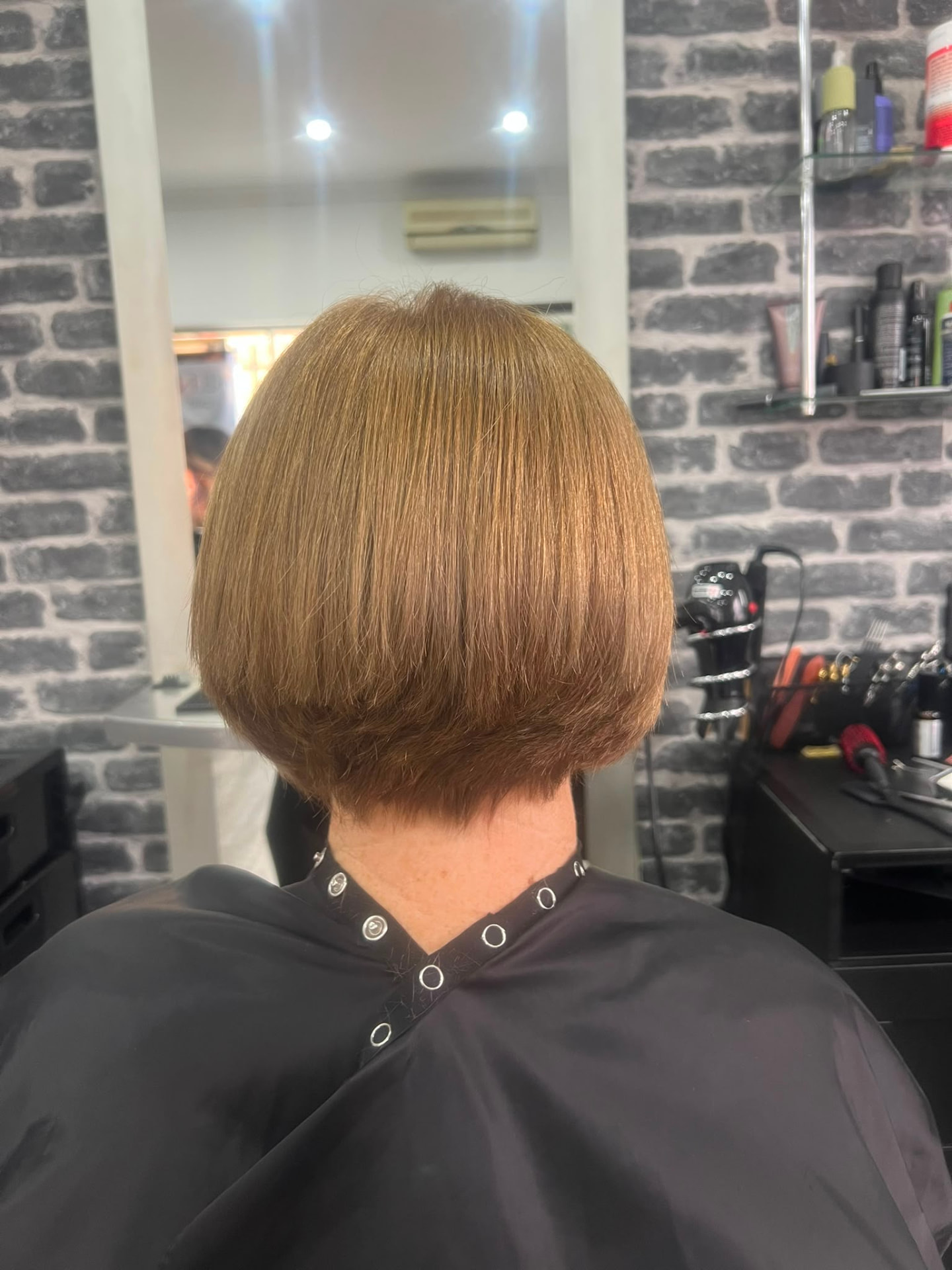 Precision rounded copper bob haircut viewed from the back