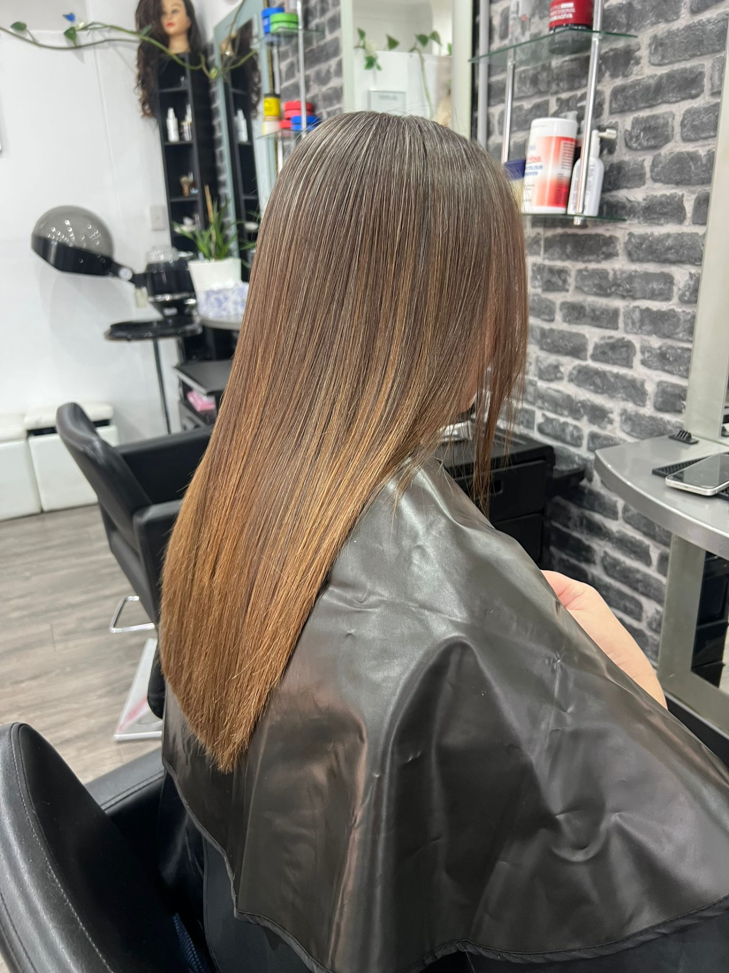 Long straightened caramel brunette hair after a nano keratin treatment