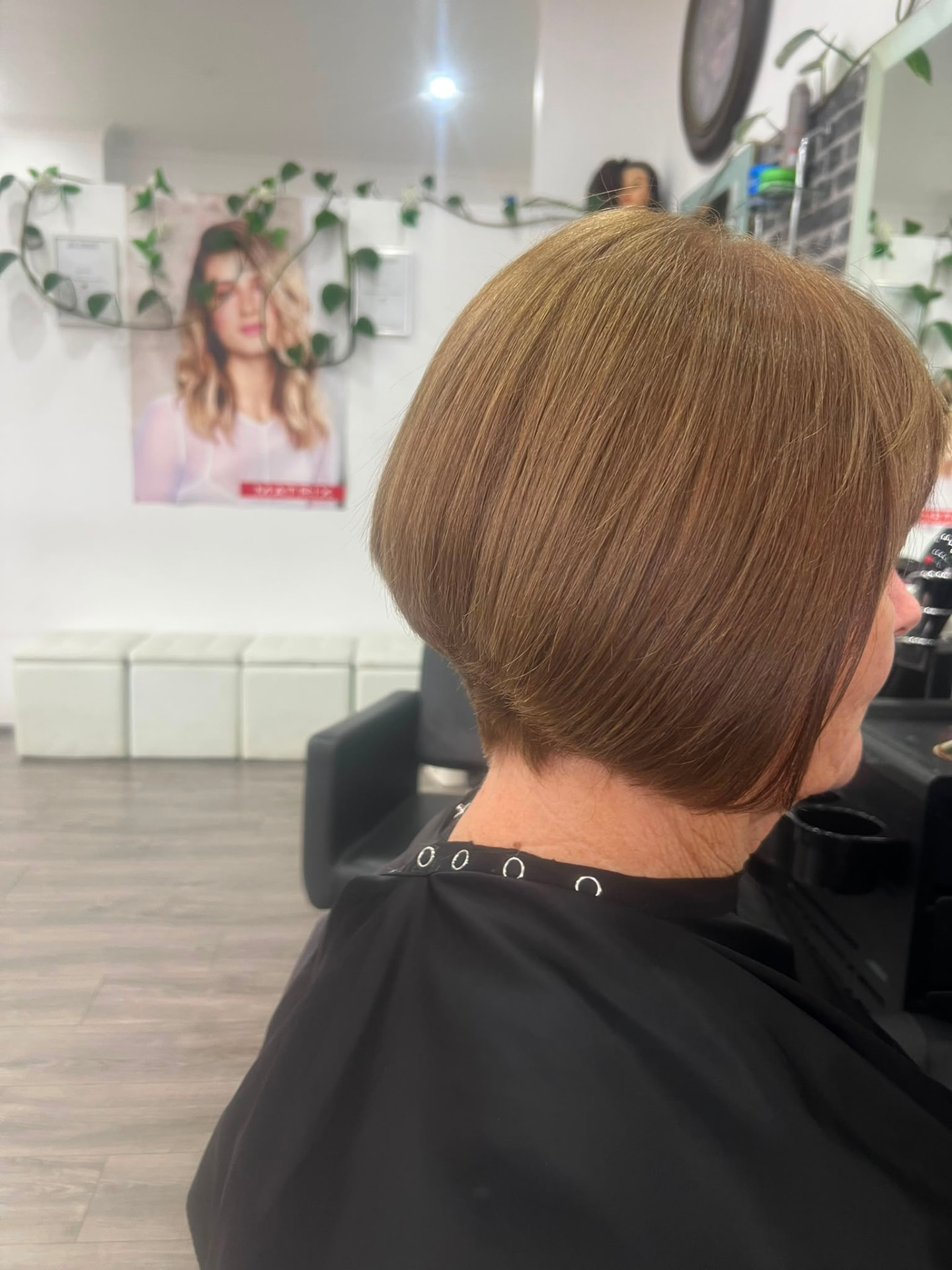 Smooth precision copper bob haircut viewed from the side