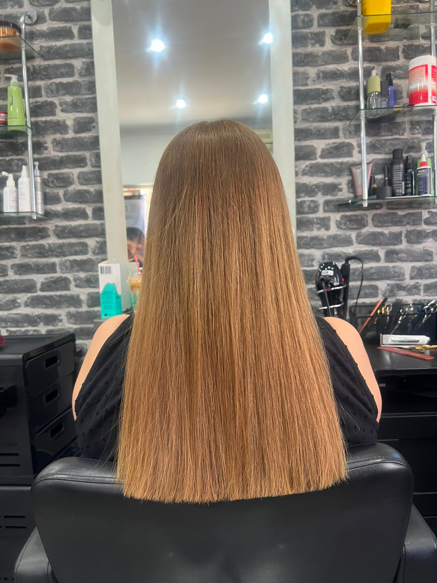 Long sleek copper hair with a precision straight finish